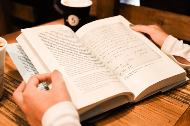 Jane Austen book open with mug