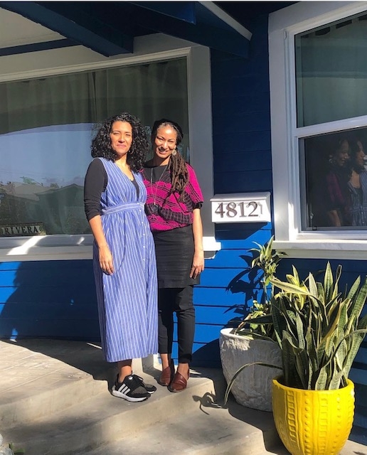 Author and friend on porch of blue house