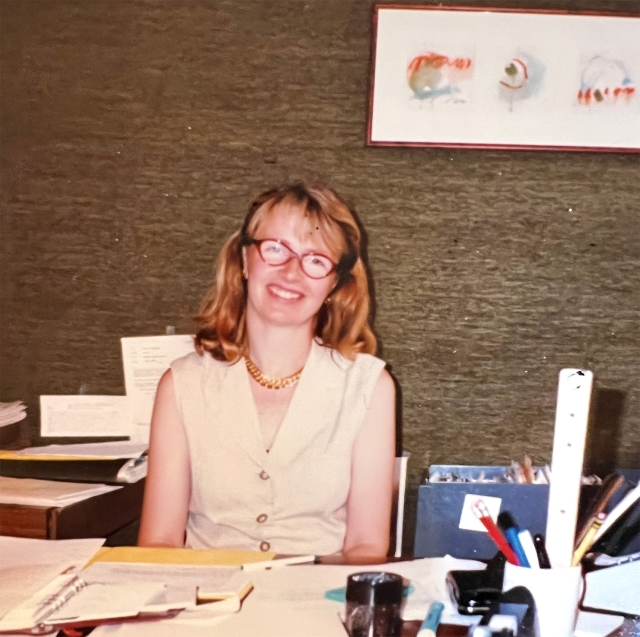 Brigitta van Rheinberg at desk.