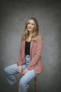 White woman wearing a pink blazer